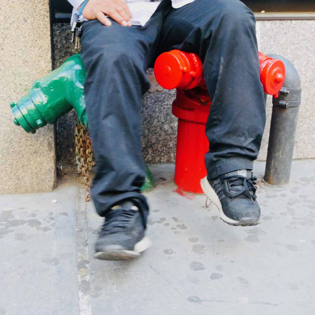 Man Sitting on Pipes