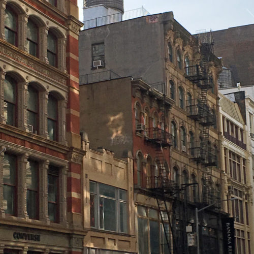 A water tower sits atop 550 Broadway